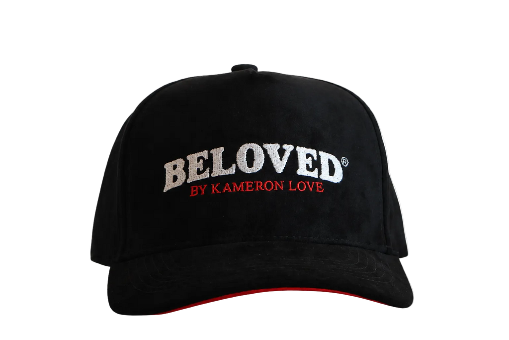 Beloved by Kameron Love black suede cap with red trim, front view